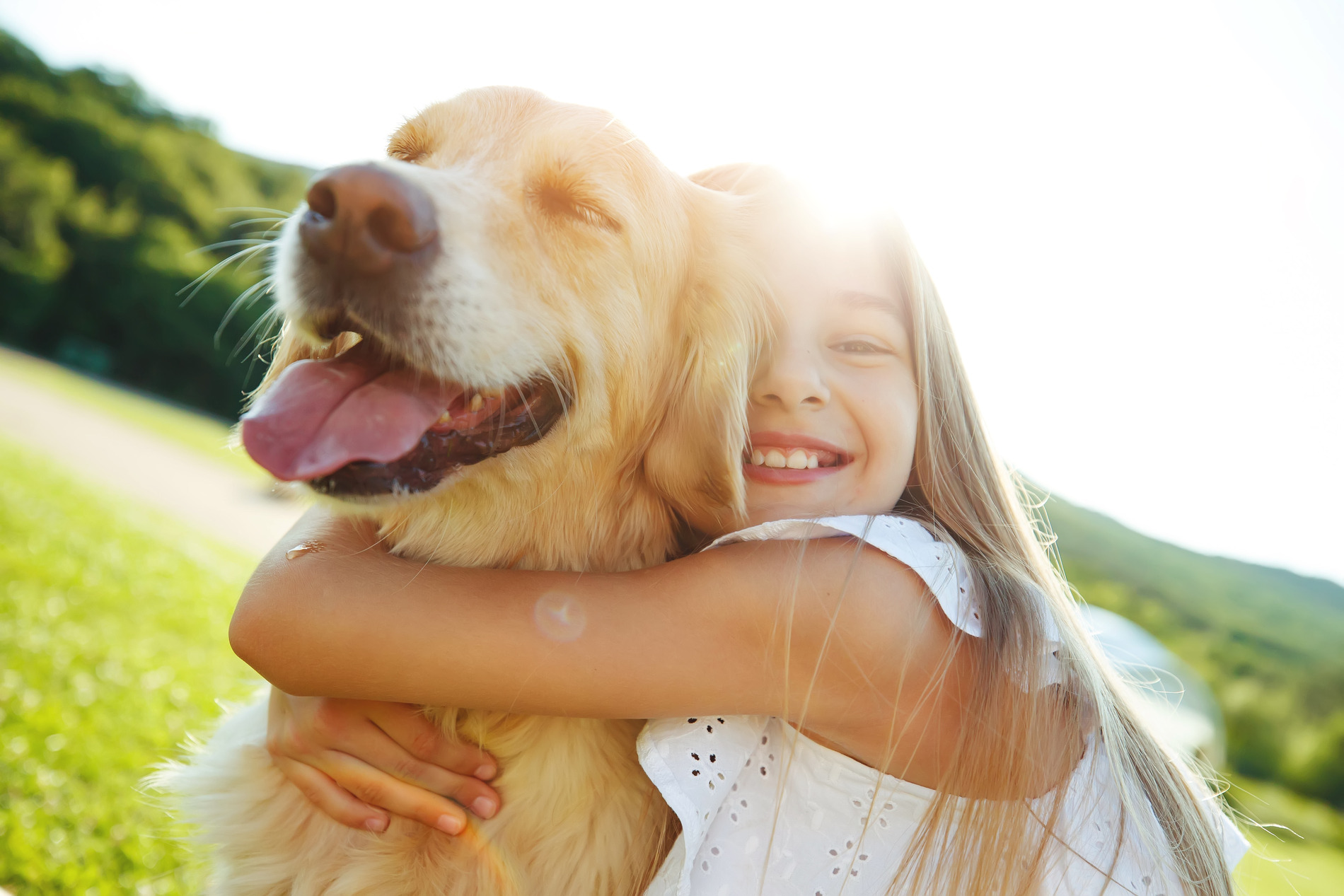 Girl hugs her healthy dog after sockwave therapy at Rosecrans Vet Clinic in Hawthorne CA
